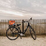 Lifestyle image of box on back of bike at the beach