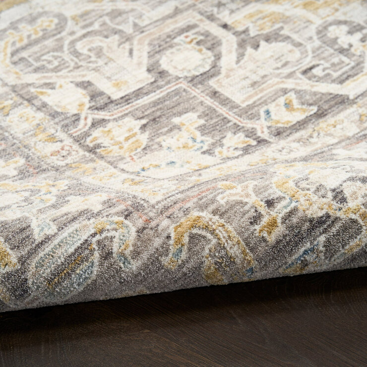 Beige and grey rug with central medallion and ornate symmetrical pattern