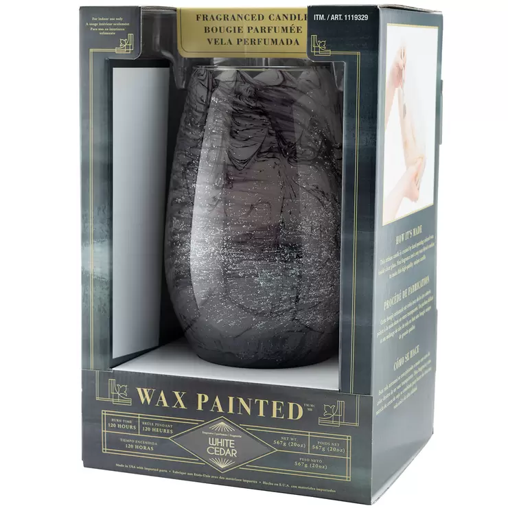Lifetsyle image of grey candle in packaging side on Lifetsyle image of grey candle in packaging side on