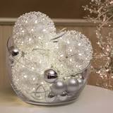 150 LED Random Sparkle spheres in a clear bowl inside the house with some silver baubles
