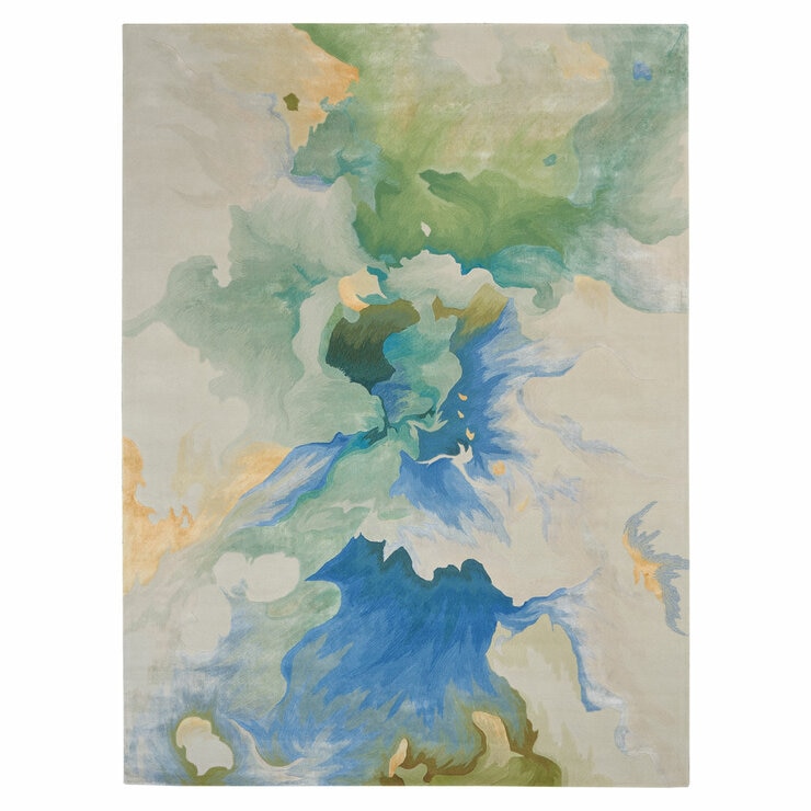 Close-up of a rug with swirling colours in green, blue, white, and yellow. The pattern has a soft, natural feel.