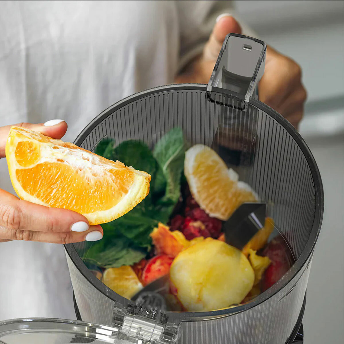 Lifestyle image of AUTO10S Juicer with smoothie ingredients inside