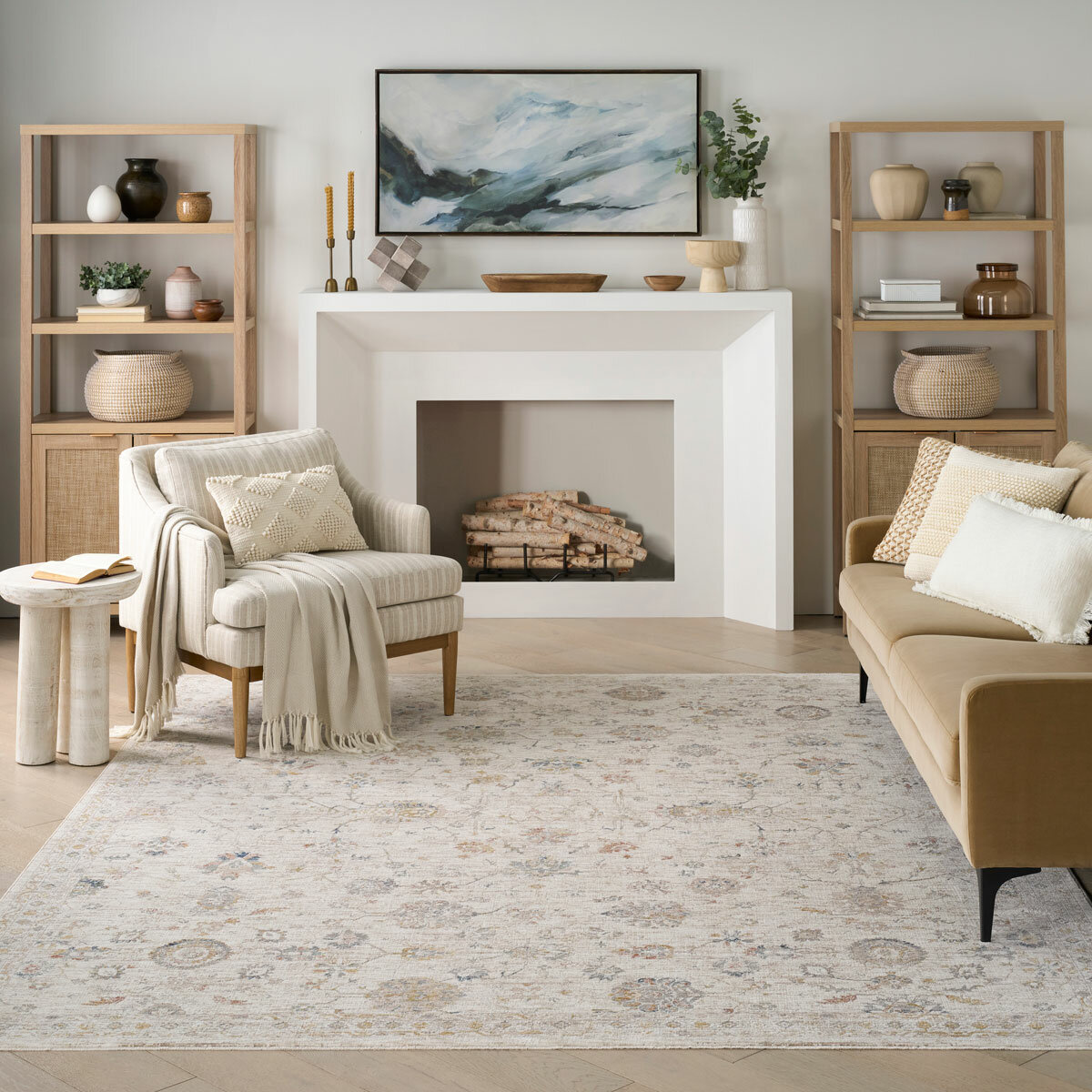 Beige rug with symmetrical floral and geometric pattern in muted blue, red, yellow, and grey