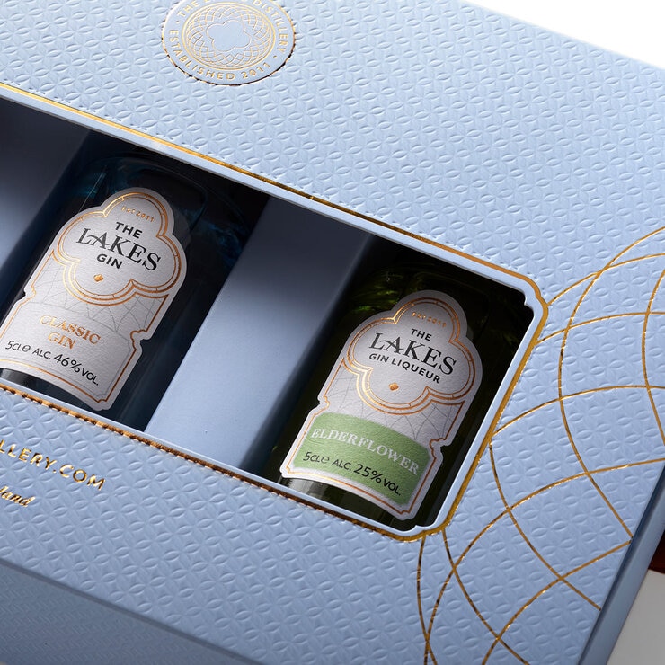 Close up of giftpack of 3 gins in blue cardboard box Close up of giftpack of 3 gins in blue cardboard box