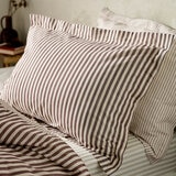 Striped duvet set with vertical burgundy and white lines, paired with matching pillowcases