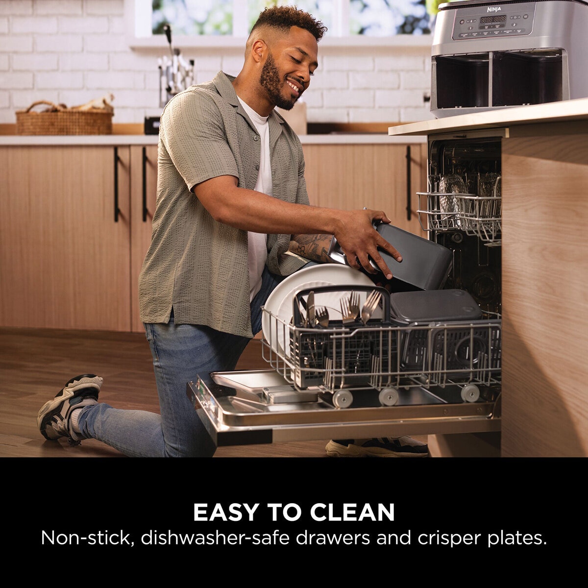 Lifestyle image of model putting dishwasher safe parts into a dishwasher Lifestyle image of model putting dishwasher safe parts into a dishwasher