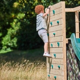 Lifestyle image of a child climbing the rock wall Lifestyle image of a child climbing the rock wall