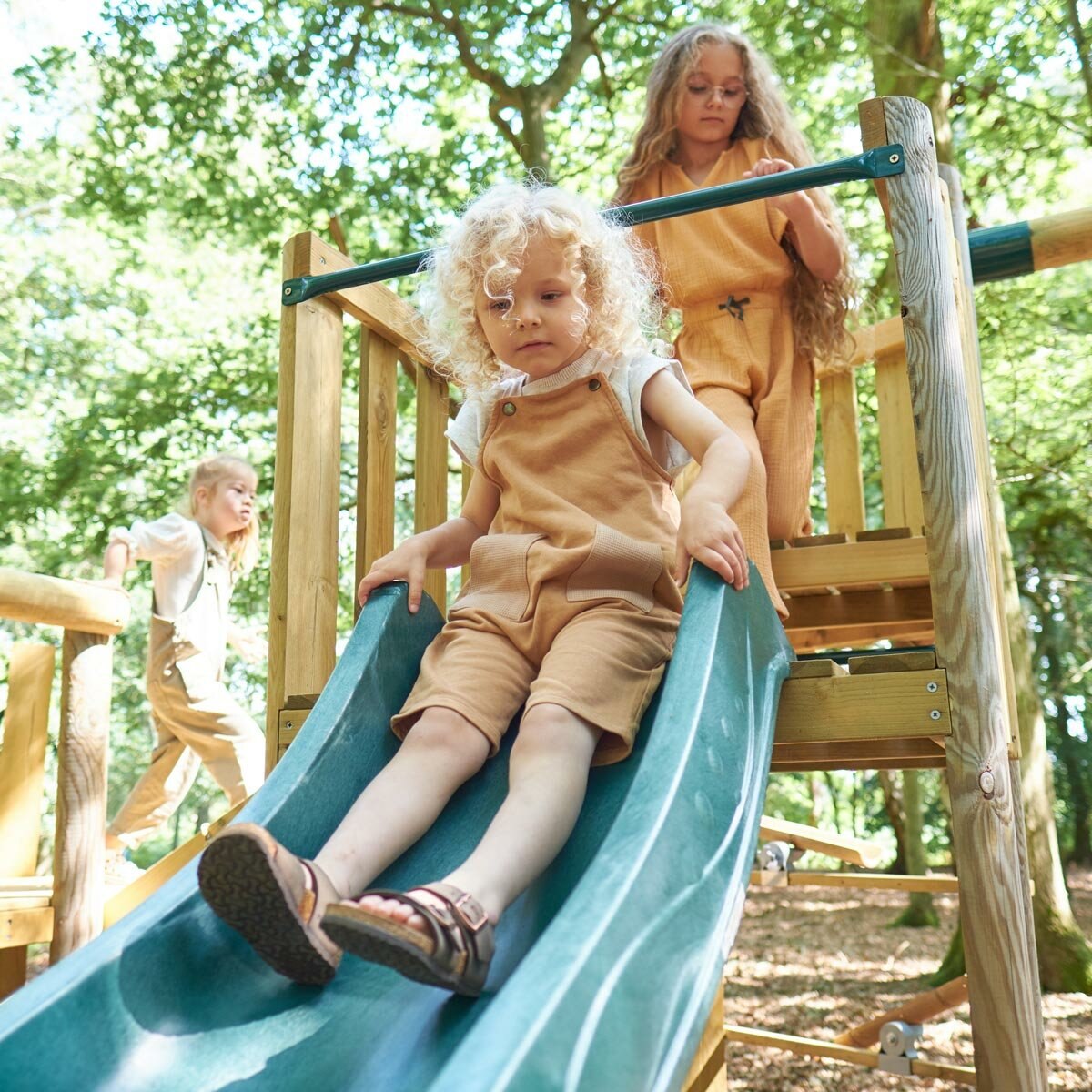 Lifestyle image of a child going down the slide Lifestyle image of a child going down the slide