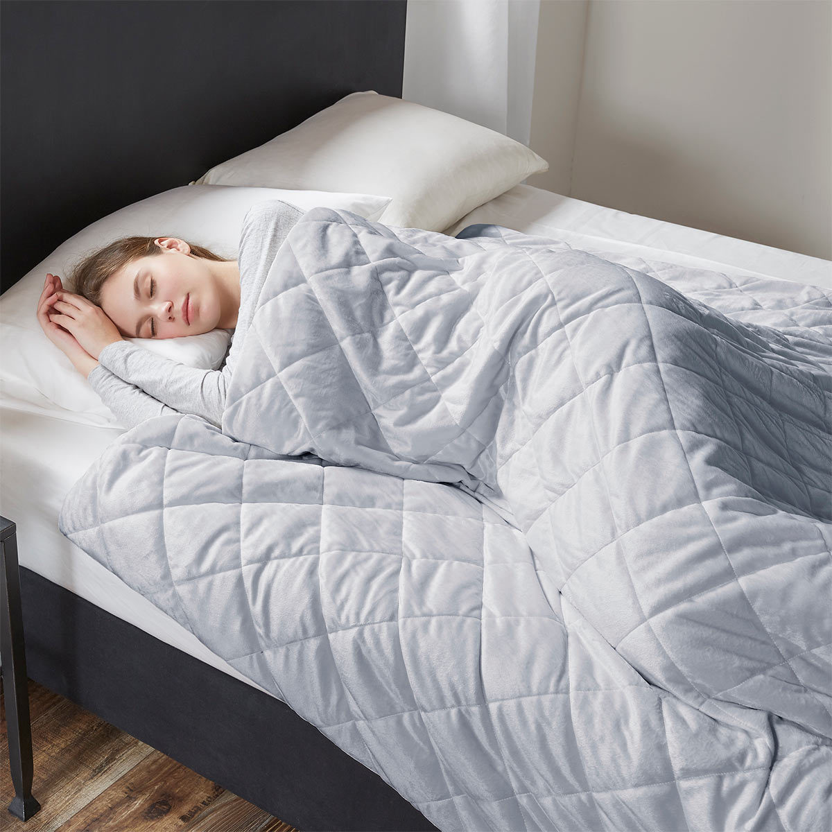 Lifestyle image of woman in bed underneath the weighted blanket