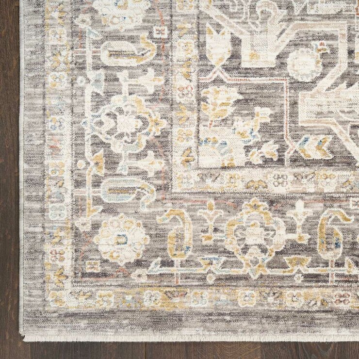 Beige and grey rug with central medallion and ornate symmetrical pattern