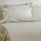 Beige and white vertically striped duvet set with matching pillowcases.