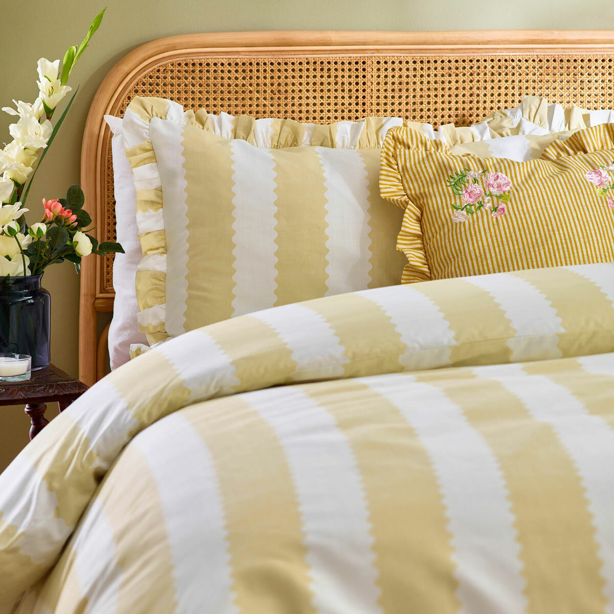 Yellow and white striped duvet set with scalloped detailing and matching pillow shams. Yellow and white striped duvet set with scalloped detailing and matching pillow shams.