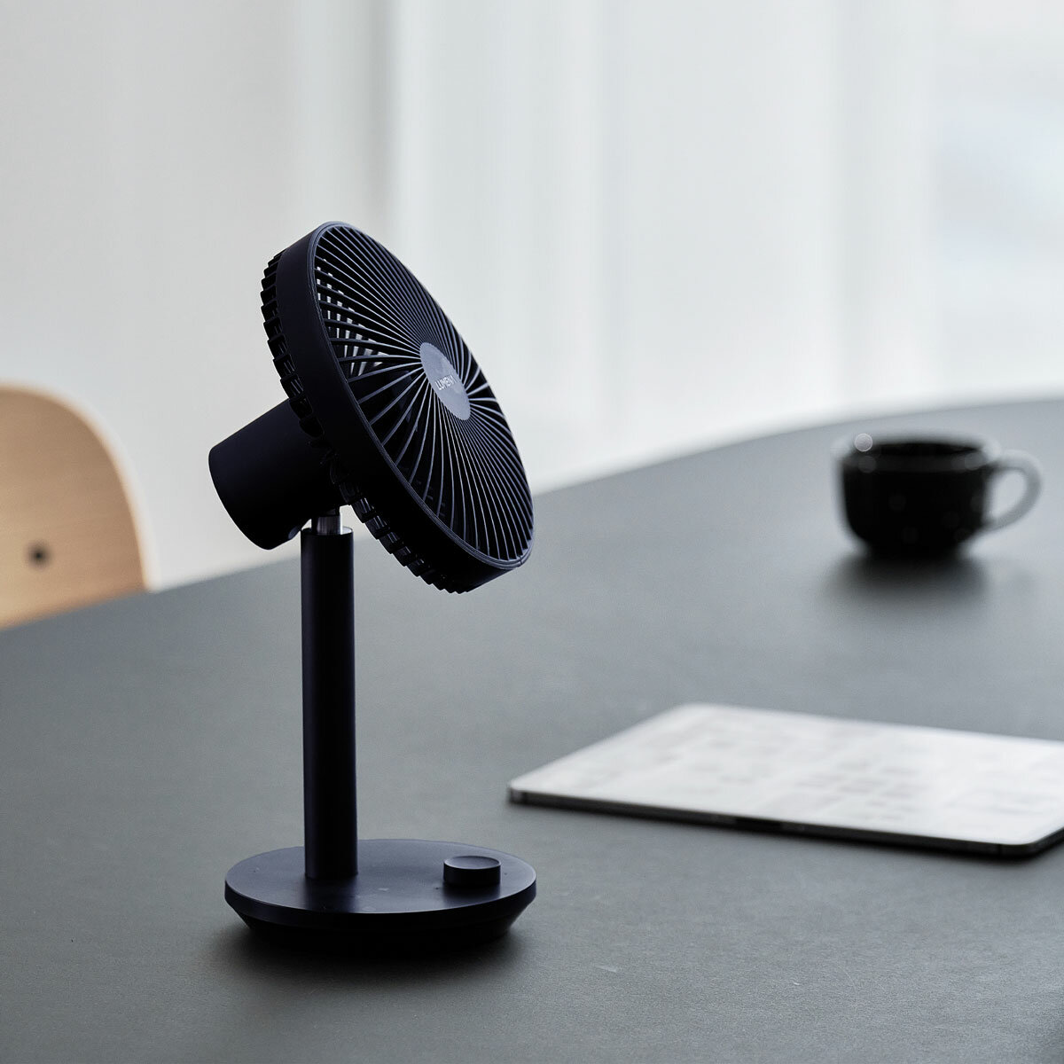 Lifestyle image of Lumena Wireless Stand Fan in navy Lifestyle image of Lumena Wireless Stand Fan in navy