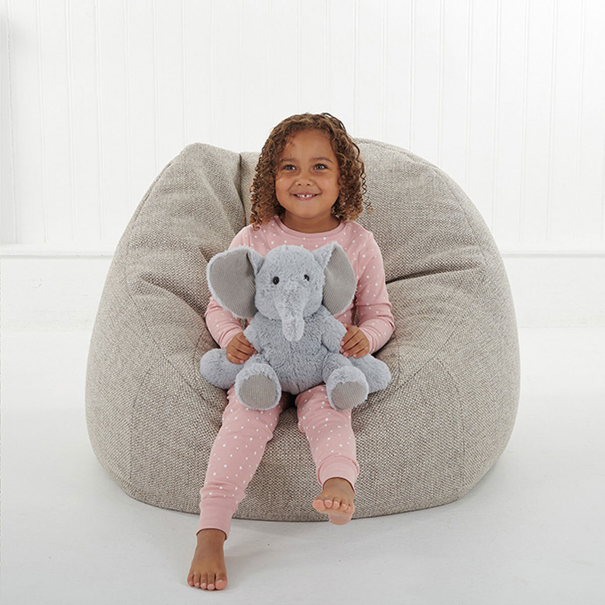 Girl Sitting Holding Elephant
