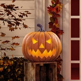 Jack O lantern pumpkin halloween decoration outside on natural background