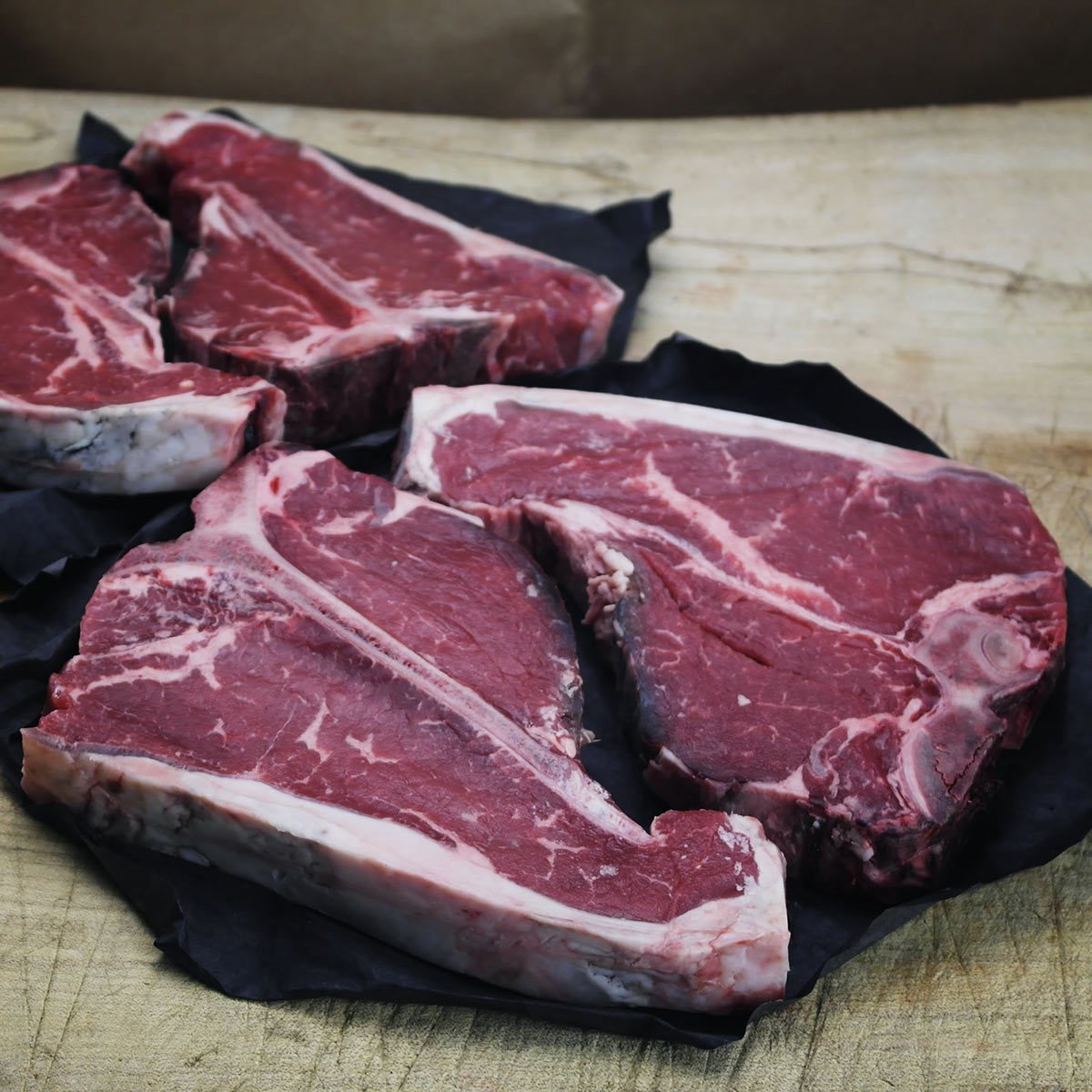 Taste Tradition Beef T-Bone Steaks, 4 x 450g presented on table