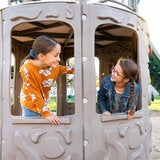Lifestyle image of two children looking at each other through the windows on the playset Lifestyle image of two children looking at each other through the windows on the playset