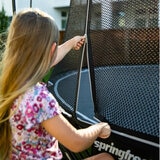 Lifestyle image of a child unzipping the net of the trampoline Lifestyle image of a child unzipping the net of the trampoline