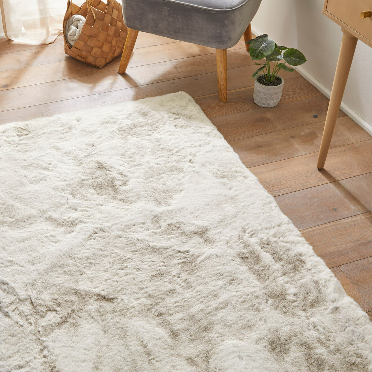 Cream-coloured fluffy textured rug on wooden floor