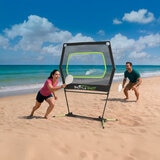 Lifestyle image showing two people playing Shuttle Shot on a beach