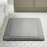 Grey bath mat styled in a modern bathroom