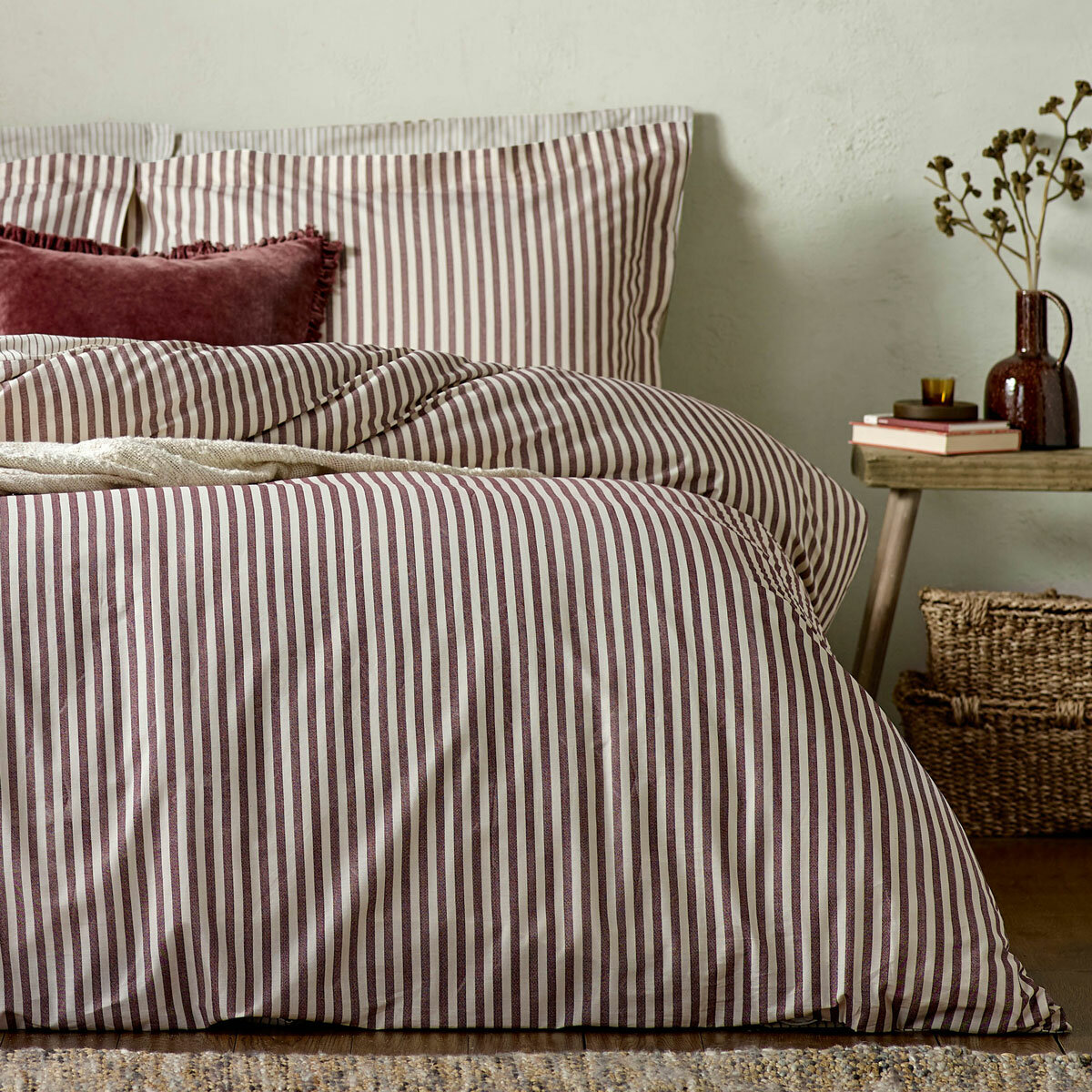 Striped duvet set with vertical burgundy and white lines, paired with matching pillowcases