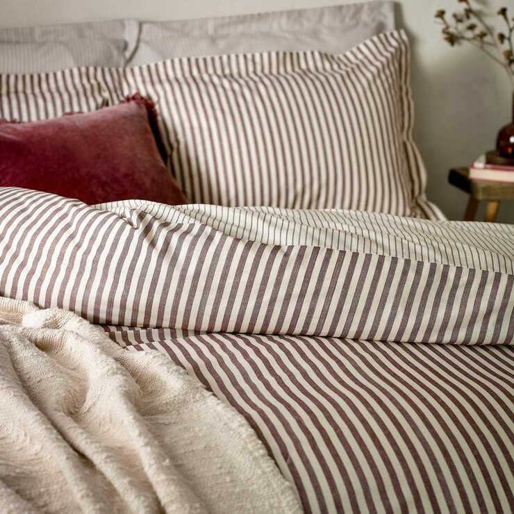 Striped duvet set with vertical burgundy and white lines, paired with matching pillowcases