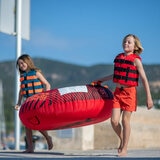 Lifestyle image of two children carrying the towable Lifestyle image of two children carrying the towable