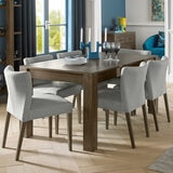 Lifestyle image of Milan Dingin table with low back upholstered chairs