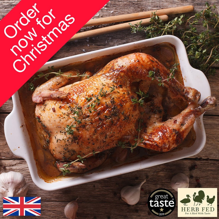Full cooked rooster on a wooden background with garlic Full cooked rooster on a wooden background with garlic