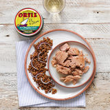 Tin of Ortiz Yellowfin Tuna in Olive Oil and Tuna Chunks Shown on a White Plate