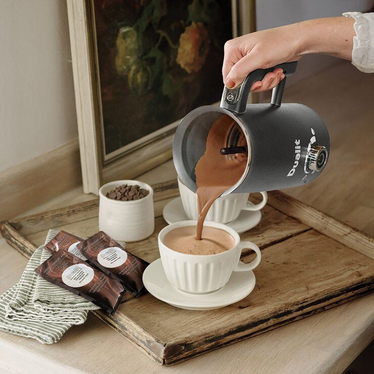 Life style image of hot chocolate being poured into a cup Life style image of hot chocolate being poured into a cup