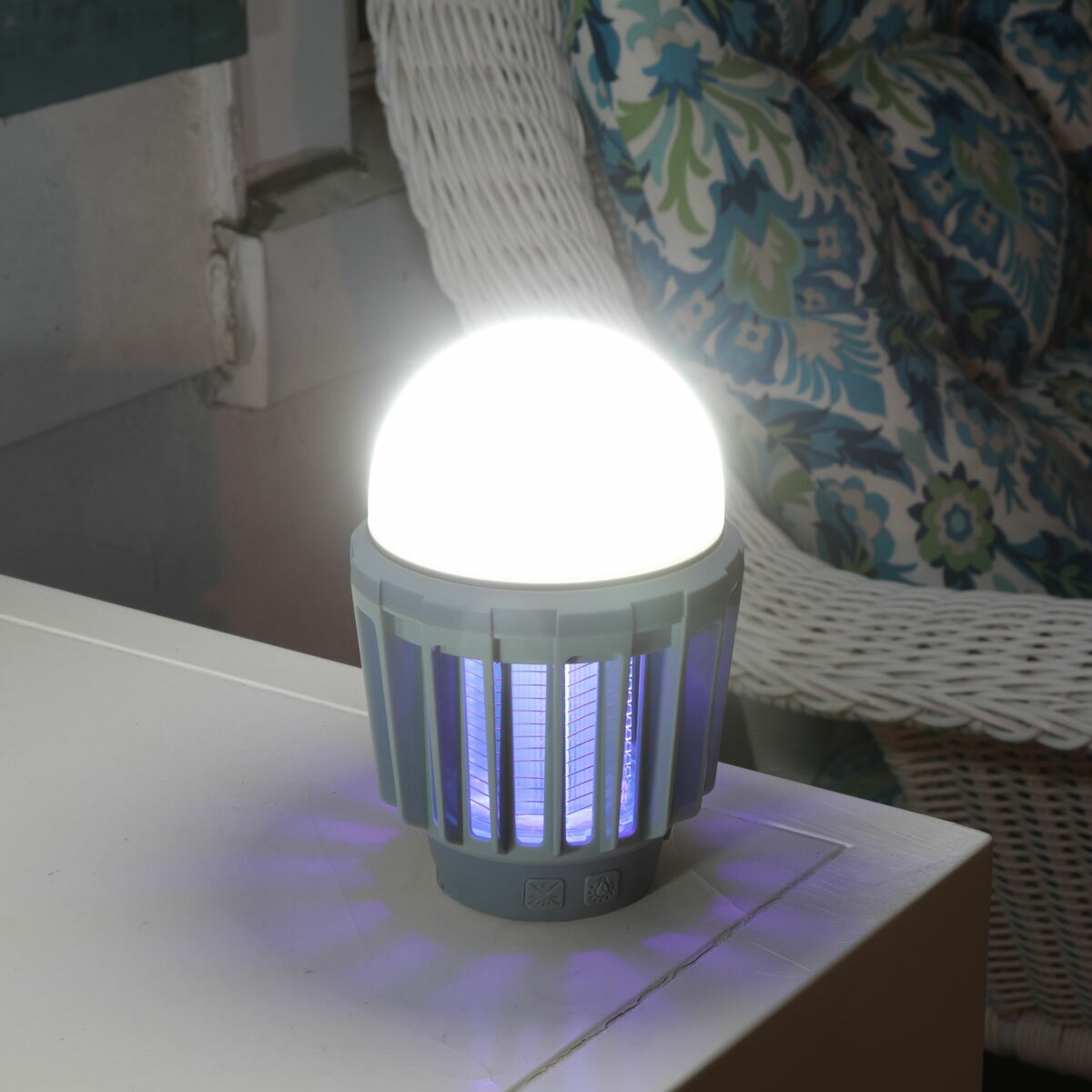 Lifestyle image showing the mosquito zapper & lantern placed on a side table with light and zapper on. Lifestyle image showing the mosquito zapper & lantern placed on a side table with light and zapper on.