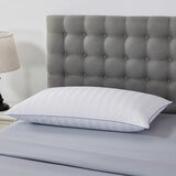 Duck fill breathable King size pillow styled on bed.