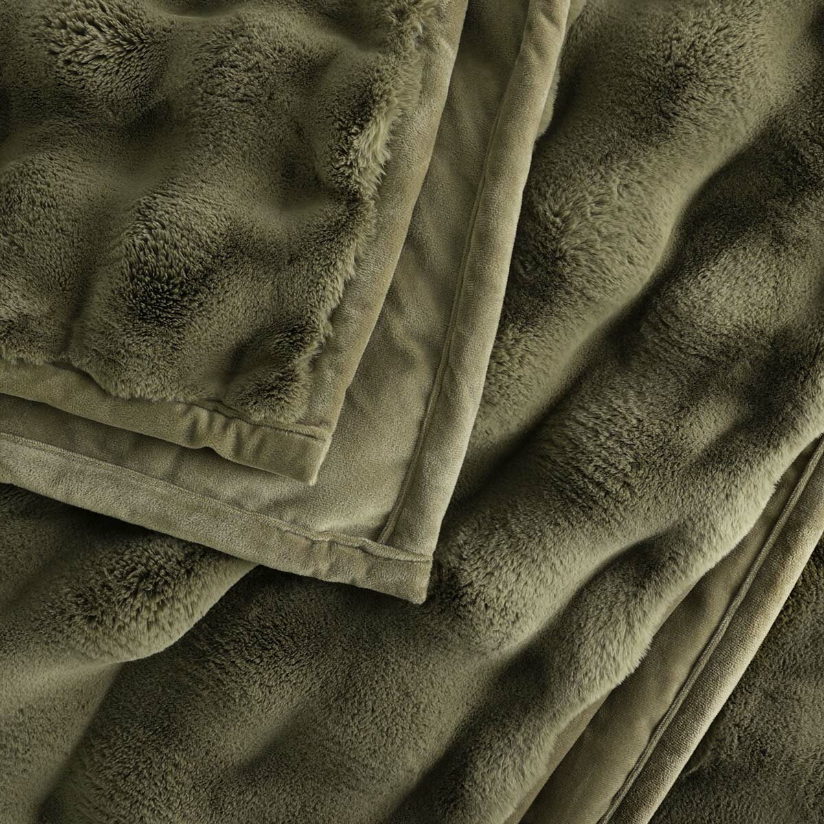 Close-up of folded olive green throw showing plush texture and stitched edge