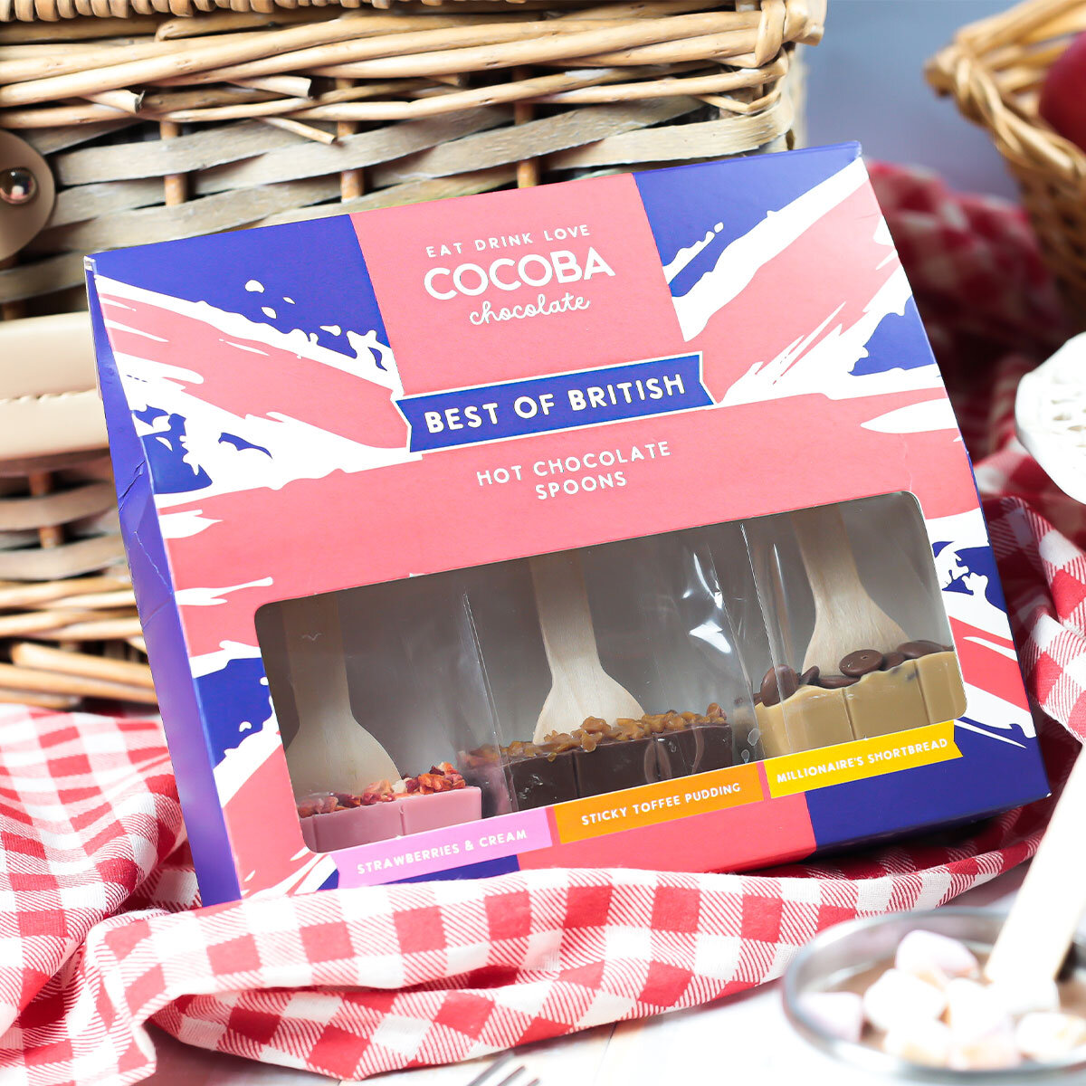 Cocoba Best Of British, Hot Chocolate Spoons, surrounded by cakes and fruit