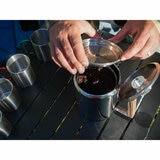 A lifestyle image of someone filling the percolator with coffee