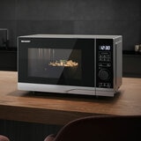 Lifestyle image of Sharp Compact 20 Litre 700W Solo Digital Microwave heating up food Lifestyle image of Sharp Compact 20 Litre 700W Solo Digital Microwave heating up food