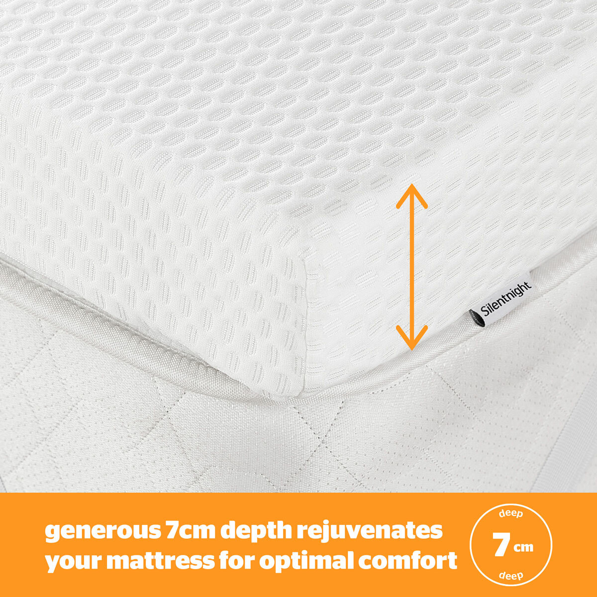 A white mattress topper with elastic corner straps fitted neatly over a mattress.