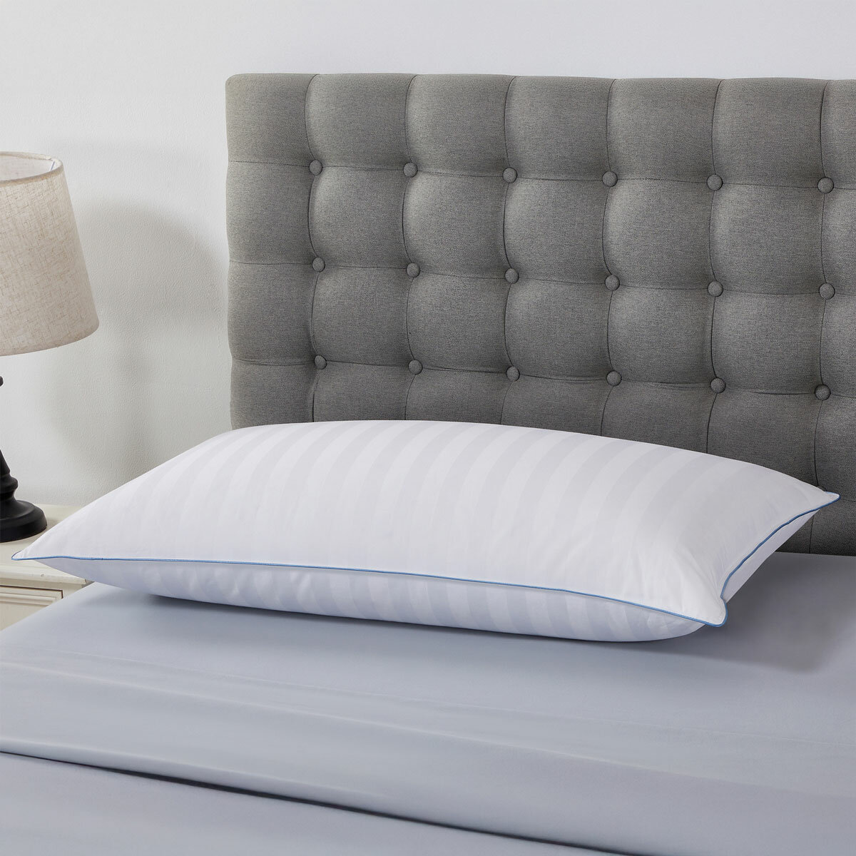 Duck fill breathable King size pillow styled on bed.