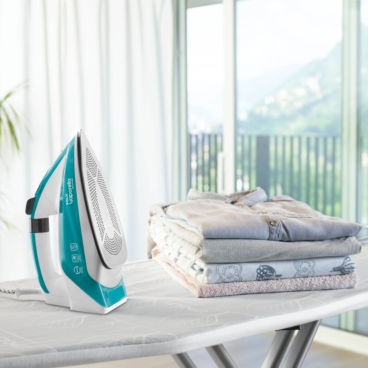 Lifestyle Image Polti Vaporella QS211 with a pile of ironing