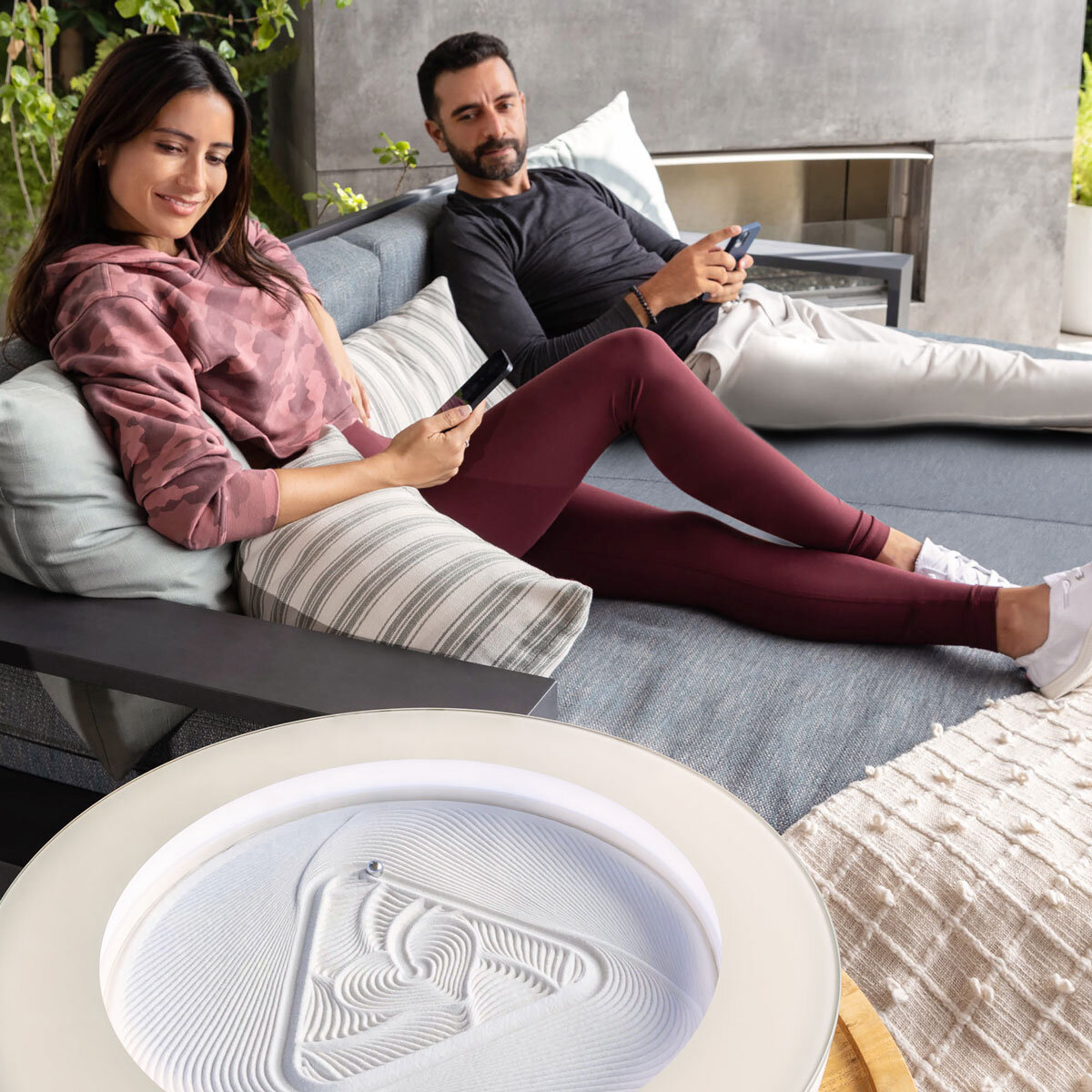 Lifestyle Image of the Homedics Drift Sandscape table next to a couple reclining