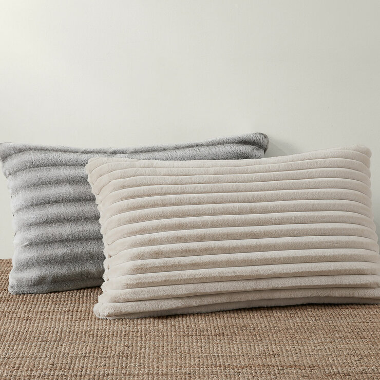 XL ribbed pillows with a plush texture resting on a textured floor