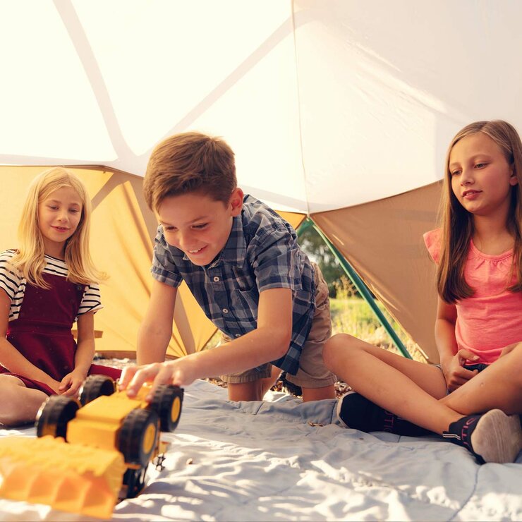 Lifestyle image showing children playing with a toy truck under the Dome Climber