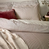 Striped duvet set with vertical burgundy and white lines, paired with matching pillowcases