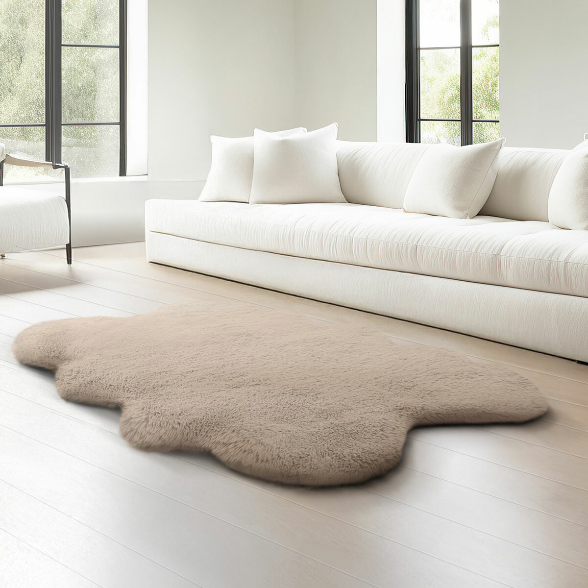 Taupe faux fur quad rug in a living room, styled next to sofa