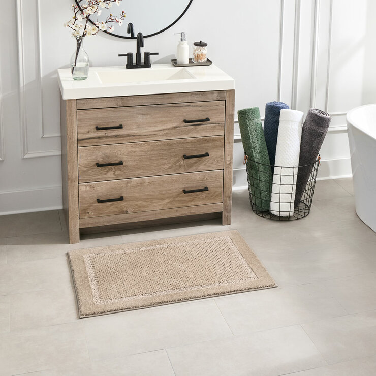 Beige bath mats with a textured surface and non‑slip backing