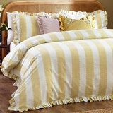 Yellow and white striped duvet set with scalloped detailing and matching pillow shams. Yellow and white striped duvet set with scalloped detailing and matching pillow shams.