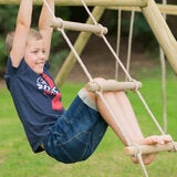 A lifestyle image of a child swinging on a cargo rope ladder A lifestyle image of a child swinging on a cargo rope ladder