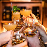 Lifestyle image of people sharing a toast with glasses of Glenmorangie